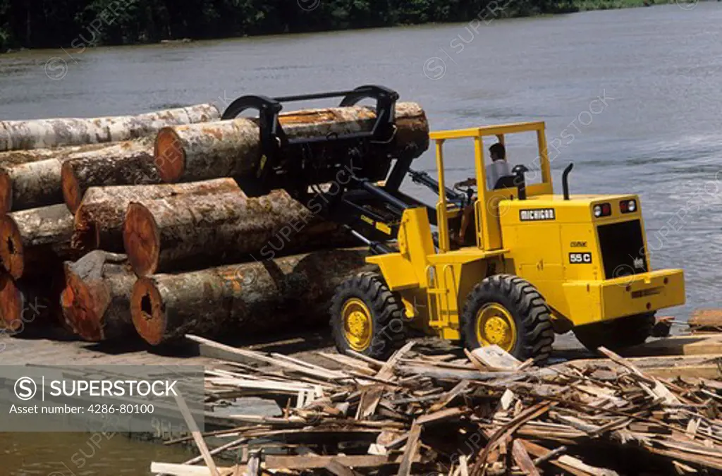 Deforestation: log loader unloading logs from barge at sawmill, Amazon estuary, Marajo Island, Para, Brazil