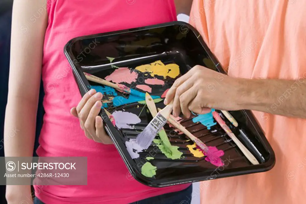 Man and Woman Holding a Paint Tray With Paint Samples, MR-0635 MR-0636