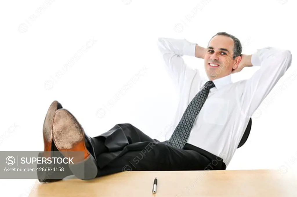 Relaxing businessman with feet up on his desk