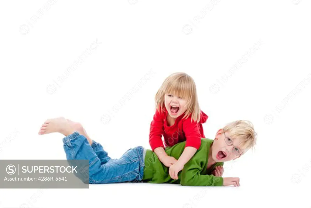 two young siblings fooling around with each other - isolated on white