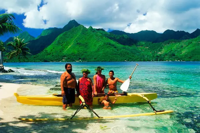 Tahitian family with their outrigger canoe at Opunohu in Moorea 