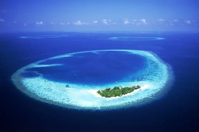 Mayafushi Island with encircling reef in Maldive Islands and Indian Ocean