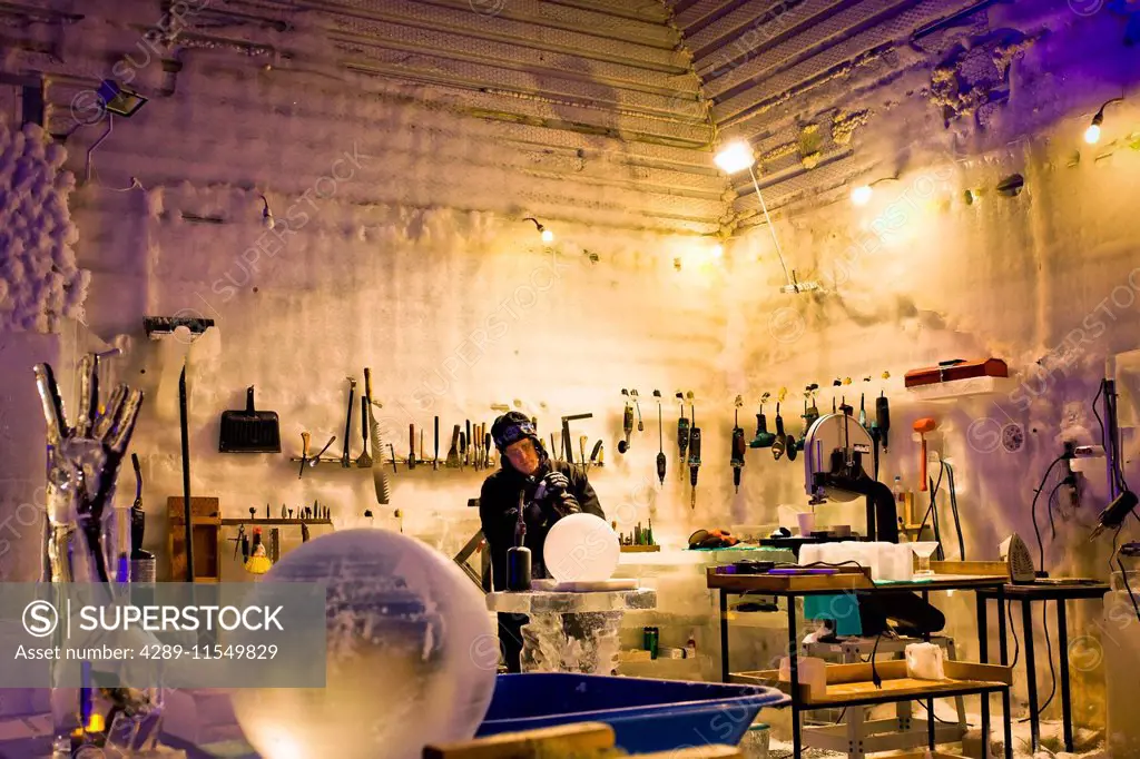 World Champion ice carver Steve Brice working in Aurora Ice Hotel Museum, Chena Hot Springs Resort, Fairbanks, Interior Alaska. Various ice carving to...