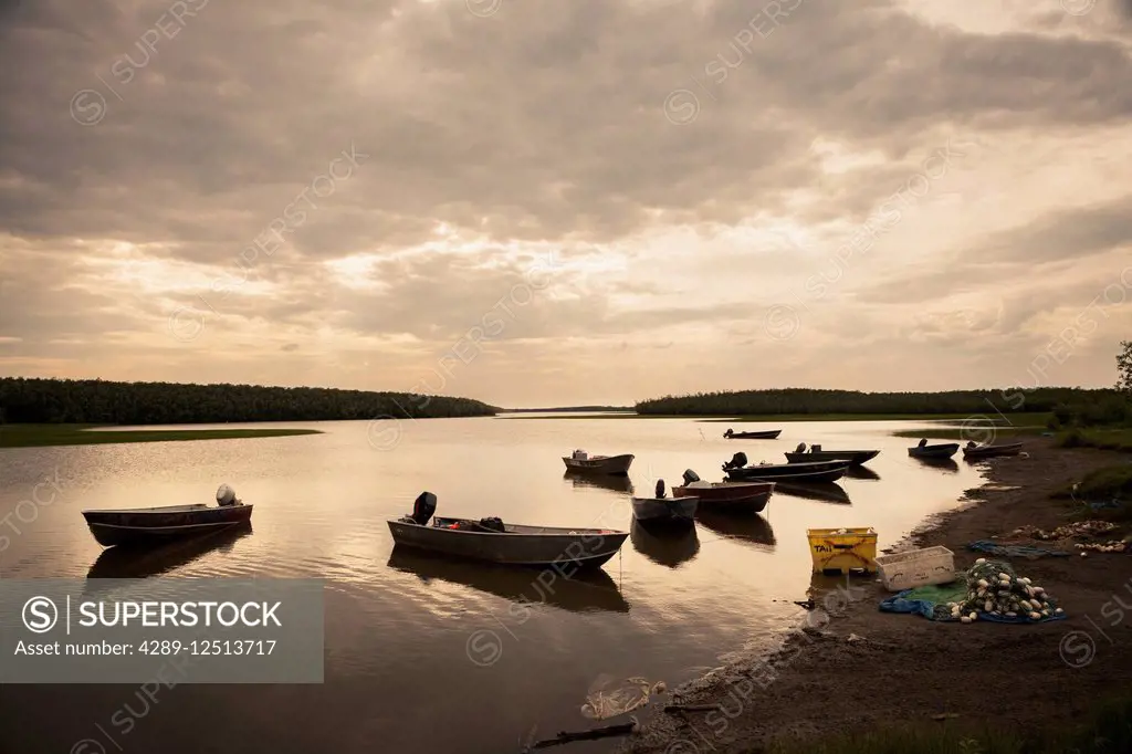 Fishing skiffs tied up on the riverbank along the Kuskokwim River in the village of Akiachak, Summer, Southwest Alaska, USA.