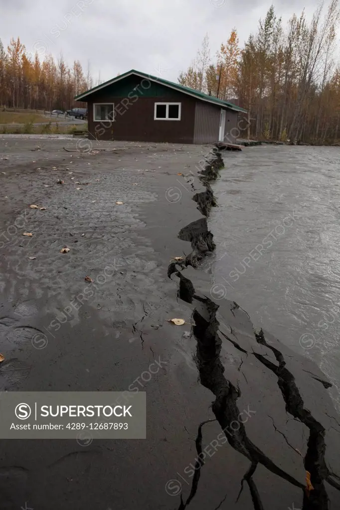 View of a house in danger of collapsing into the flooding Matanuska River, Palmer, Southcentral Alaska, autumn