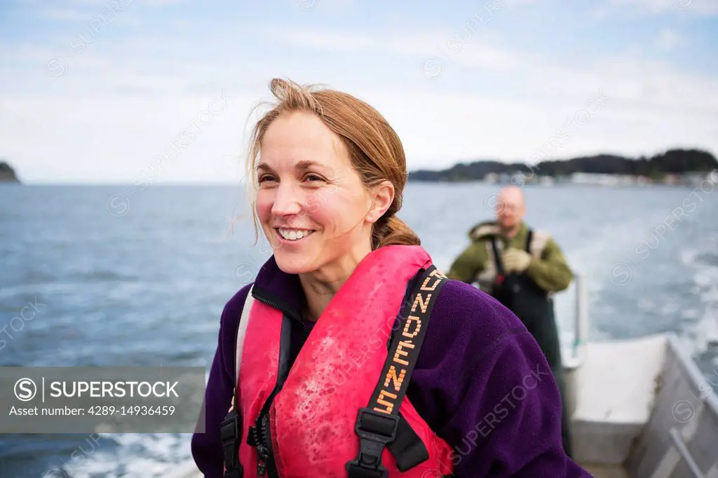 Female and husband drives a set-net skiff in Seldovia Bay, South-central Alaska; Alaska, United States of America