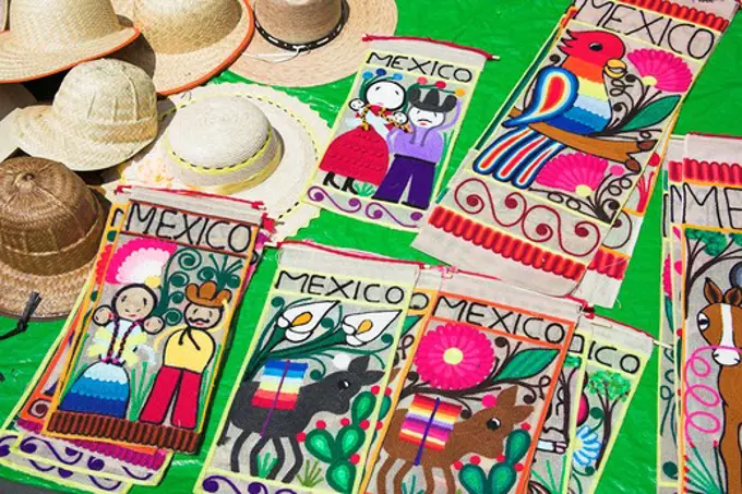 Hats and embroidered Mexican wall hanging souvenirs for sale, Zocalo, Mexico City, Mexico