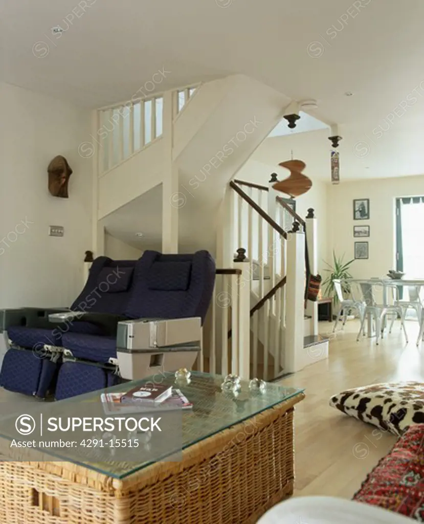 Glass-topped wicker chest in modern open-plan living and living room