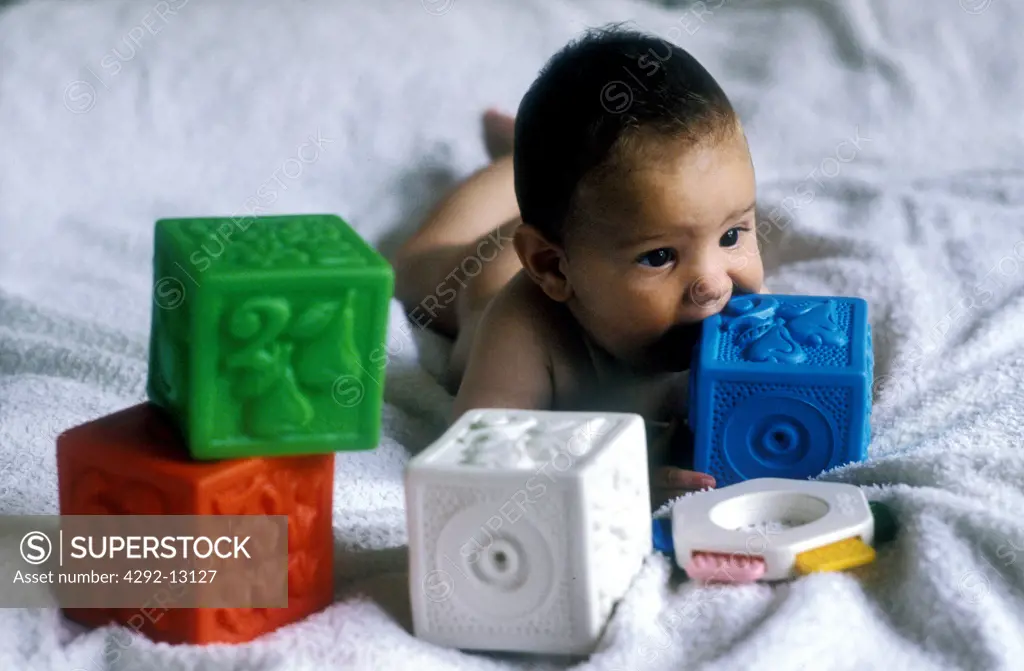 Baby playing with plastic cubes