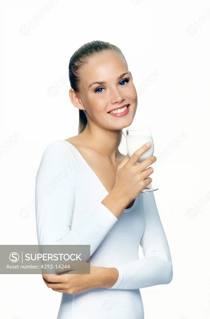 Portrait of a woman with a glass of milk