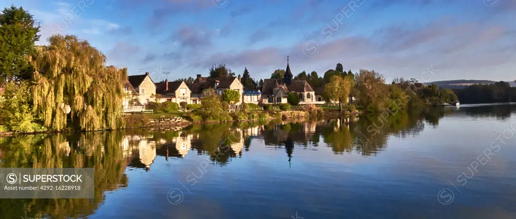 in autumn,The Seine river, Riverbank in Normandy, France, Bas Cléon area, thatched cottage in traditionnal normandic style