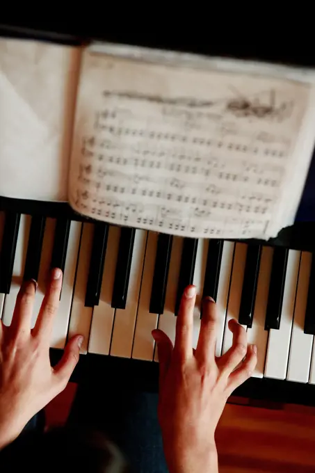 Playing piano, hands close up