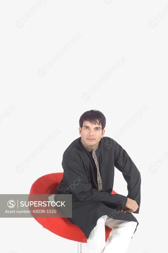 Young man sitting on swivel chair, portrait