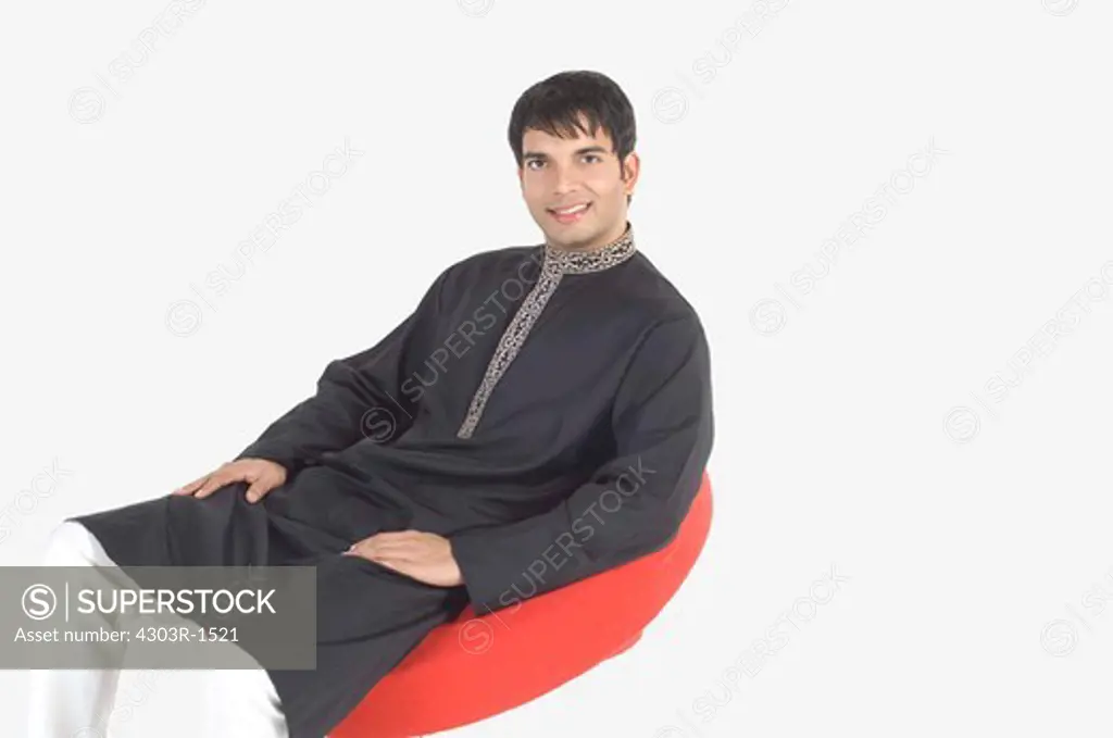 Young man sitting on swivel chair, portrait