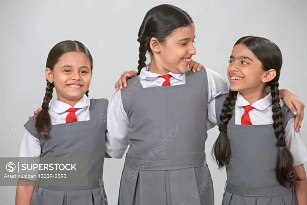 Three school girls laughing together