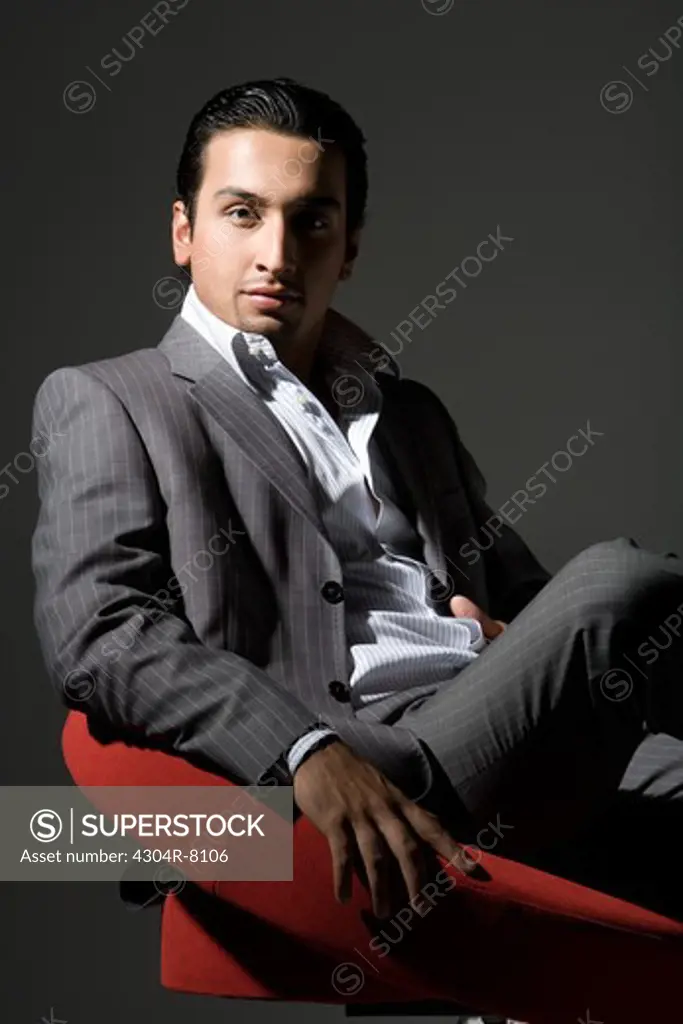 Young man sitting on swivel chair, portrait