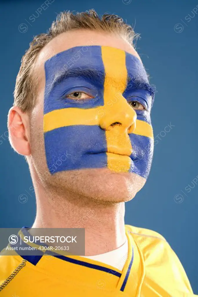 A man with the Swedish flag painted in his face.