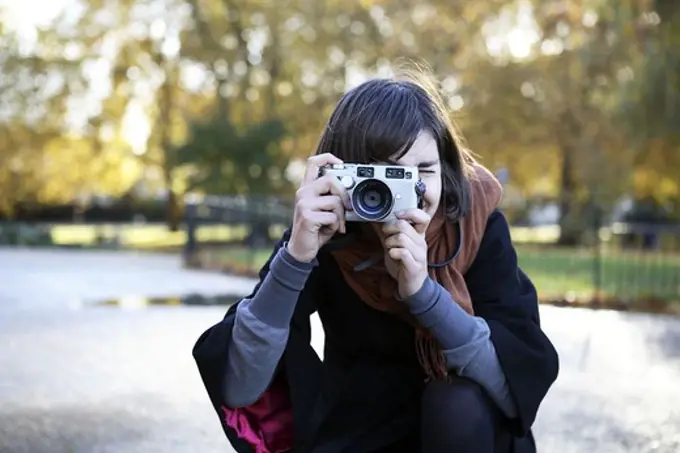 A woman taking a picture, London, Great Britain.