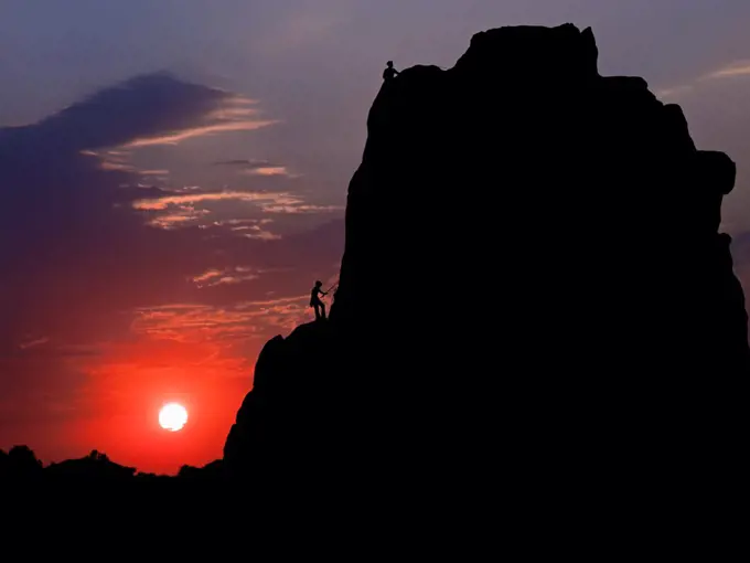 Rockclimbers Silhouetted by Sun