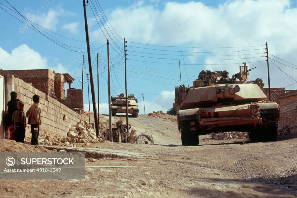 Young Iraqi Children Gaze at a Passing US Marine Corps M1-A1 Abrams Tank During a Combat Operation in Haqlaniyah, Iraq