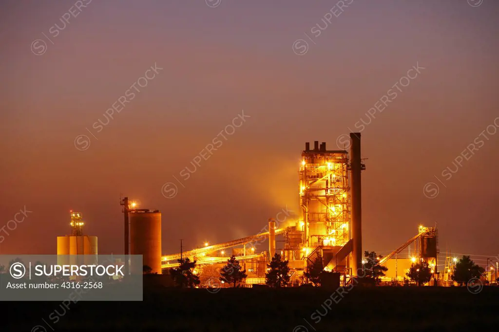 Dusk view of a cement factory in Woodland, California.