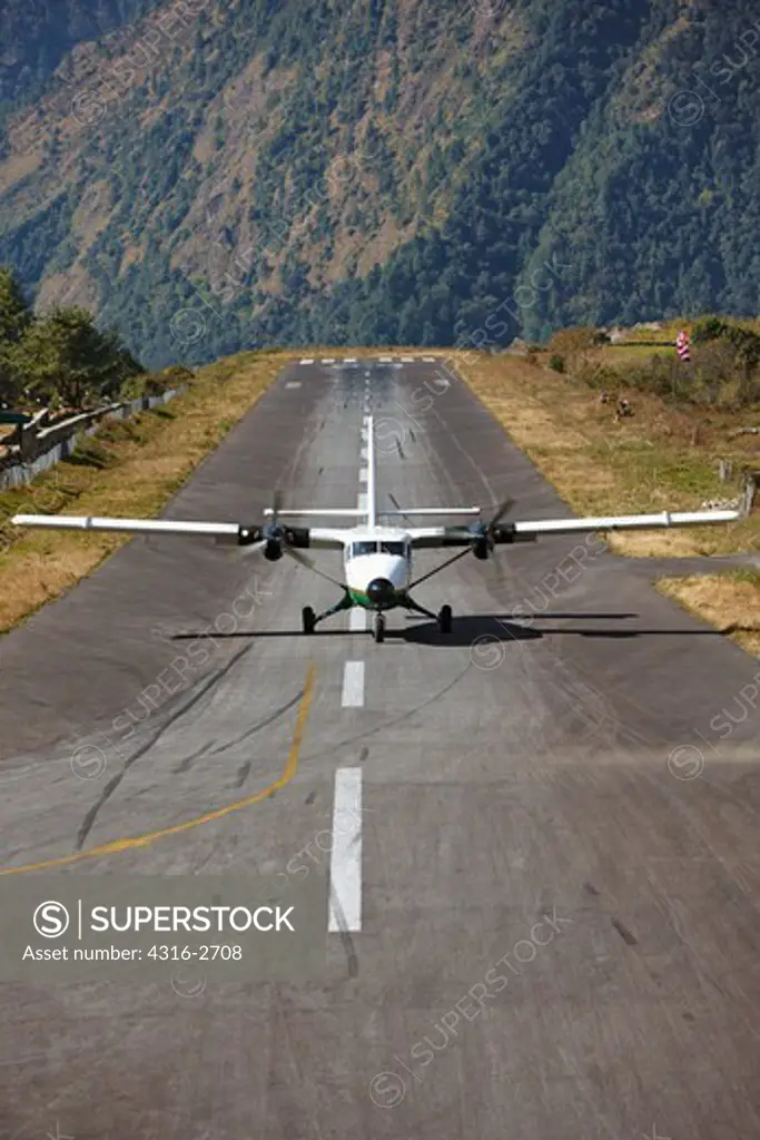 A Dornier 228 STOL (Short Takeoff and Landing) aircraft taxis after landing at the short runway at the airport at Lukla, in the Mount Everest region of Nepal.