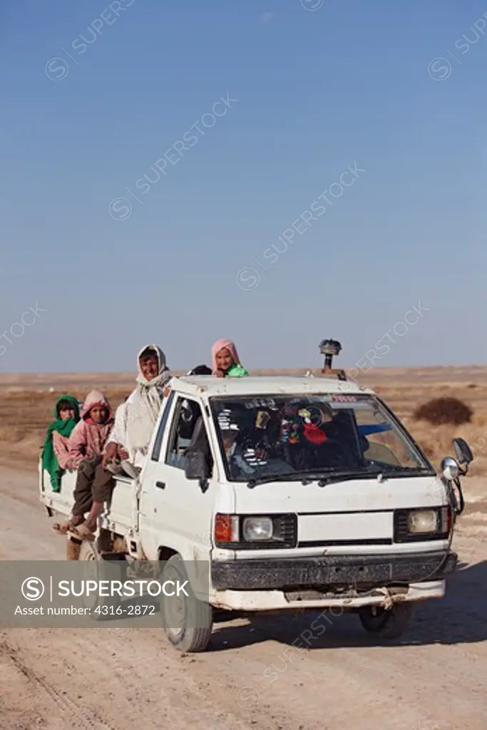 A  Kia Bongo truck carrying local Afghans in Afghanistan's southern Helmand Province.