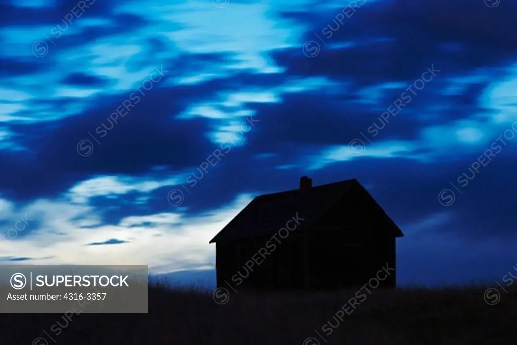 Silhouette of an abandoned schoolhouse, from the Dust Bowl era, at Buckingham, Colorado.