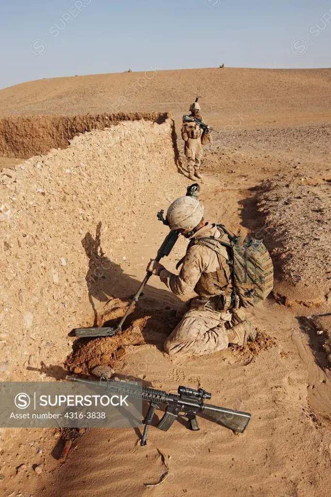 U.S. Marine Combat Engineer Searches for Weapons Caches and Explosive Devices Using a Metal Detector During a Combat Operation in Afghanistan's Helmand Province