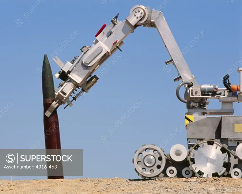 An Explosive Ordnance Disposal Robot Grips a 155mm High Explosive Artillery Round