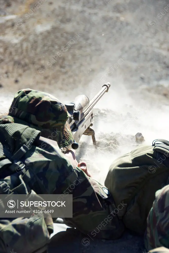 British Royal Marine firing a sniper rifle during mountain sniper training, Hawthorne, Nevada, USA