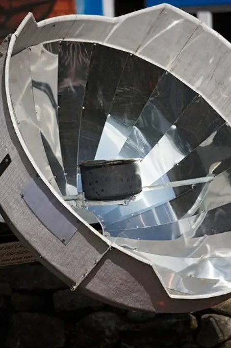 A parabolic solar water heater heats a bowl of water at Lukla, Nepal, in the Mount Everest region.