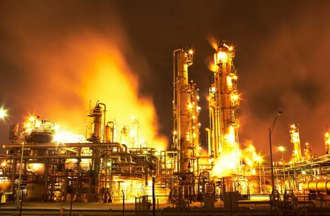 Night view of fluid catalytic cracking unit at a petroleum processing facility, Pasadena, Houston, Texas, USA