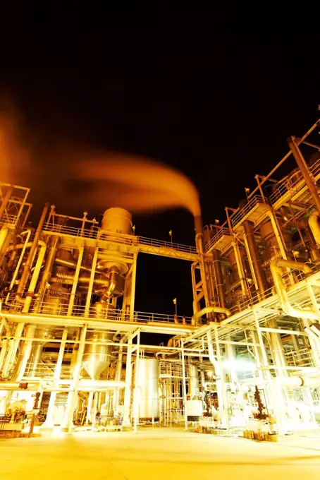 Large tomato processing factory at night, Central Valley, California, USA