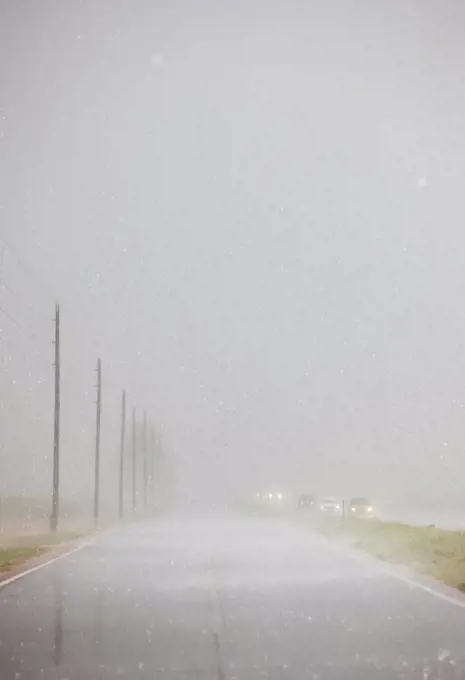 Interstate highway and frontage road during a dangerous thunderstorm dropping hail, Colorado, USA