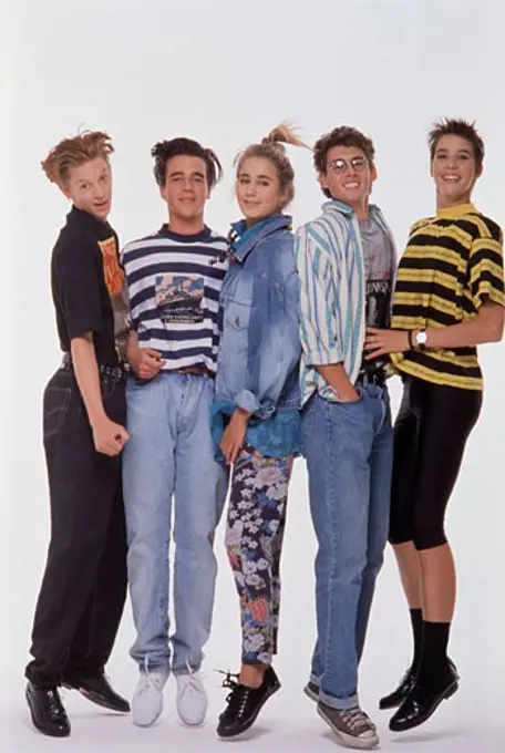 Portrait of two teenage girls and three teenage boys posing and smiling