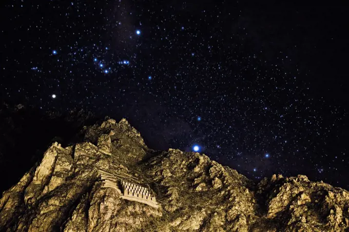 Inca Storehouses and Night Sky in Ollantaytambo, Peru