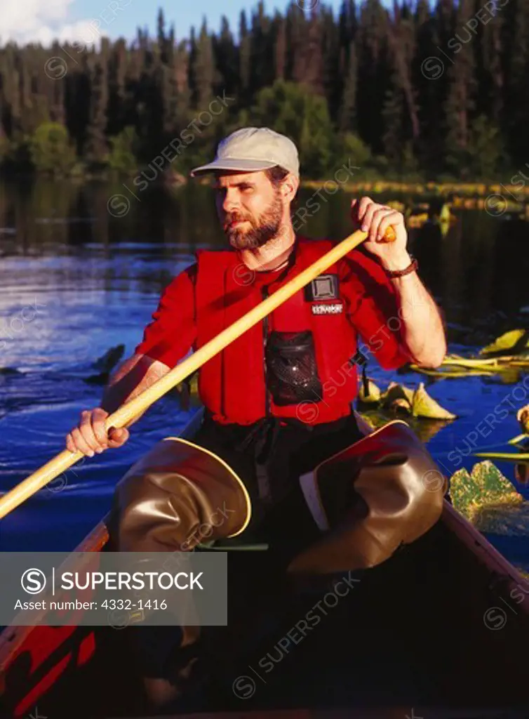 Scott Stolnack paddling canoe on Canoe Lake #1 of the Swan Lake Canoe Trail, Kenai National Wildlife Refuge, Kenai Peninsula, Alaska.