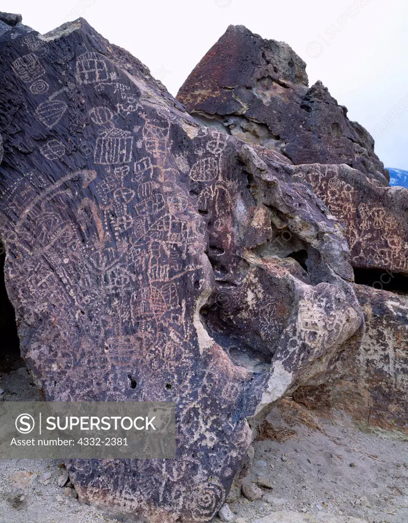 Petroglyphs of the Great Basin Abstract Style carved on dark, vesicular basalt, Chidago Canyon, California.