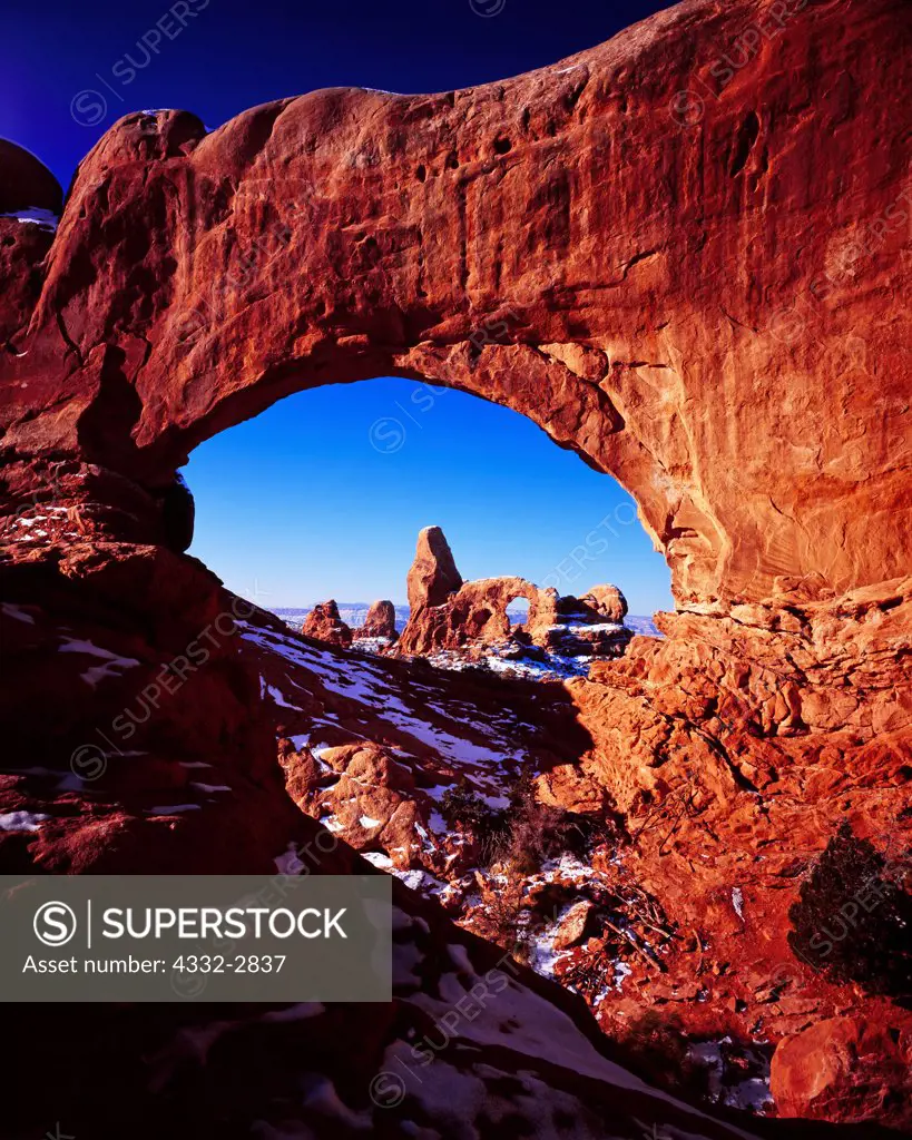 Turret Arch viewed through the North Window in winter, The Windows Section, Arches National Park, Utah.