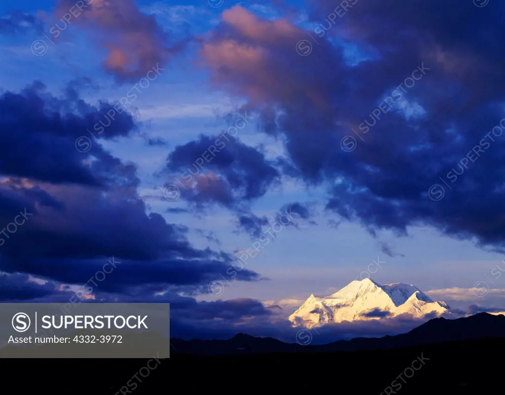 West side of Mount Foraker viewed through clouds from alpine tundra above Boulder Creek near Grandview Lodge, Porkypile, Alaska.