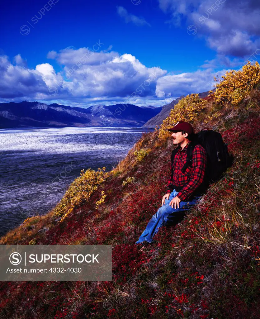 Fred Hirschmann enjoying view while hiking above the Nelchina Glacier, Chugach Mountains, Alaska.