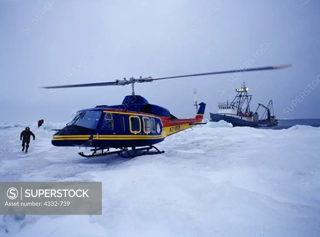 North Slope Borough Search and Rescue Bell 214ST (Super Transport) helicopter delivering emergency radio equipment to the boat 'Big Valley' trapped by pack ice northwest of Barrow, Alaska.