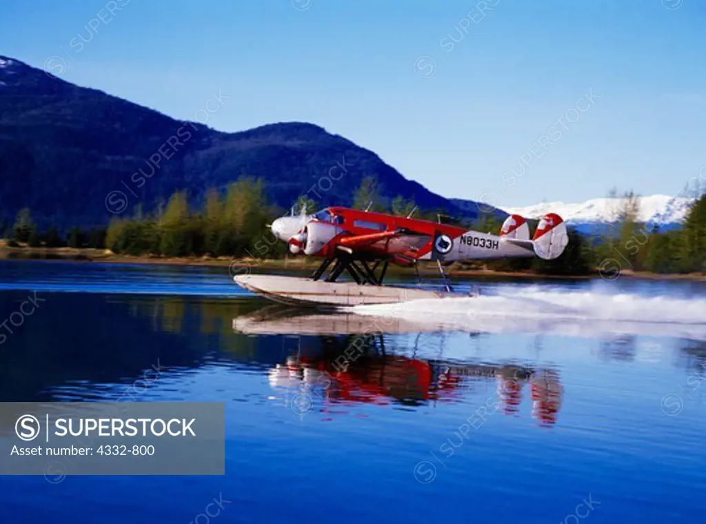 Alaska Coastal Airlines' Twin Beech 18 built in 1944 taking off from float pond at the Juneau Airport, Alaska.