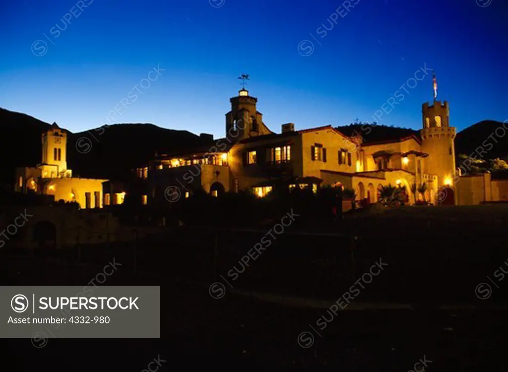 Scotty's Castle, Power House and Chimes Tower illuminated at dusk, Death Valley Ranch, Death Valley National Park, California.