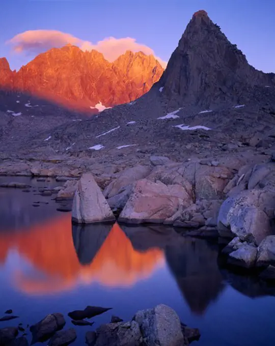 Thunderbolt Peak, North Palisade and Isosceles Peak reflected at sunset in one of the Dusy Lakes, Dusy Basin, Sierra Nevada, Kings Canyon National Park, California.