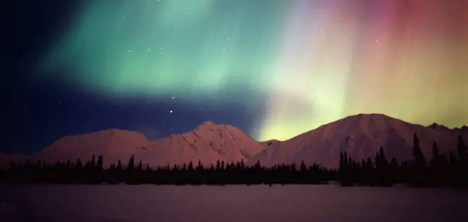 Beautiful green, red and purple aurora above the Talkeetna Mountains and Colorado Lake, geomagnetic storm during the early morning hours of March 31, 2001, Broad Pass, Alaska.