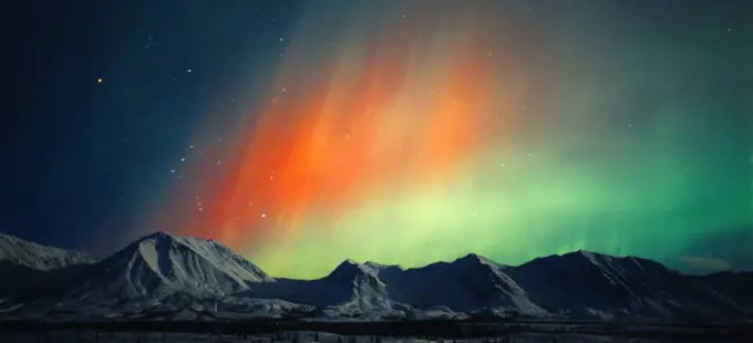 Beautiful red and green aurora over the Talkeetna Mountains during geomagnetic storm during early morning hours of October 28, 2001, Broad Pass, Alaska.