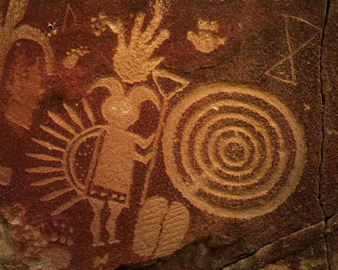 Petroglyphs of Ghaan'ask'idii, Humpbacked God, concentric circles and the hourglass symbol of Born-for-Water, Gobernador Representational Style, Largo Canyon tributary, Dinetah, New Mexico.