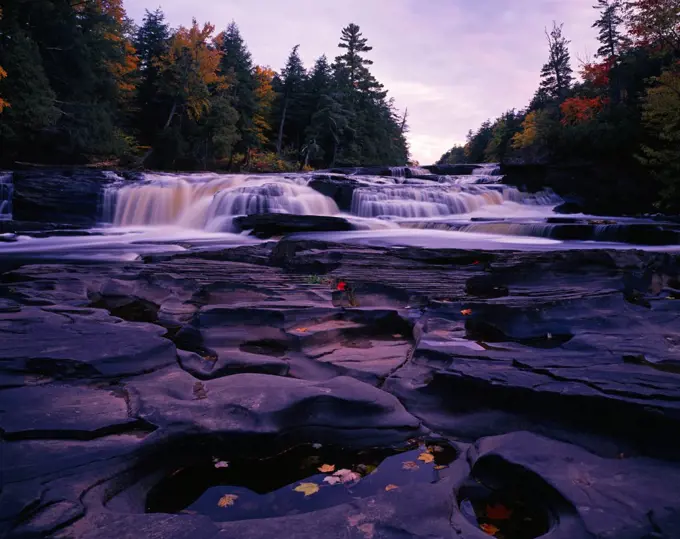 Maple leaves in potholes, Manido Falls on the Presque Isle River, Porcupine Mountains Wilderness State Park, Upper Peninsula of Michigan.